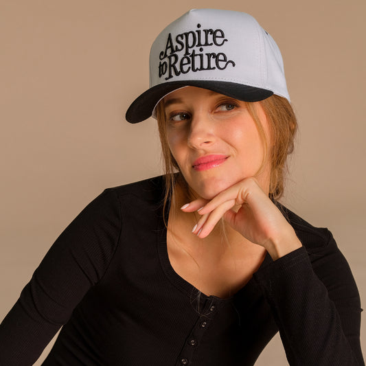 CC ASPIRE TO RETIRE BLACK TRUCKER CAP